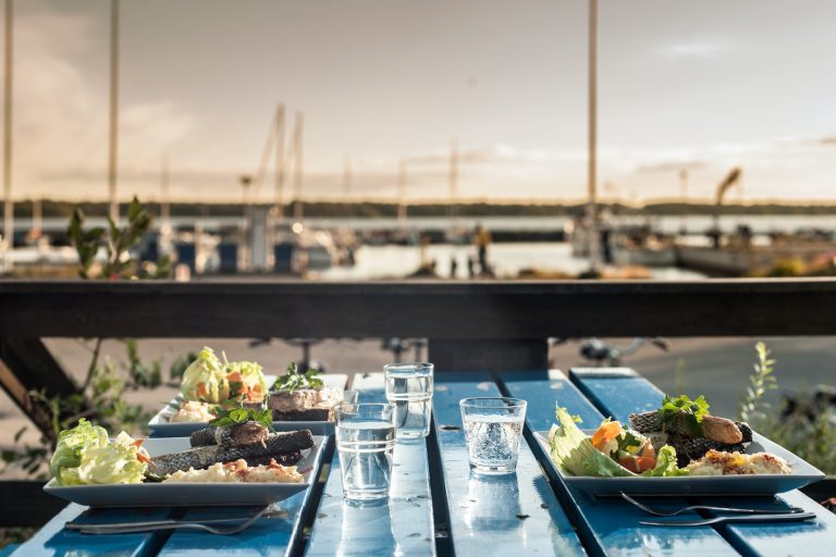 Table set with meals by marina, Reykjavik, Iceland